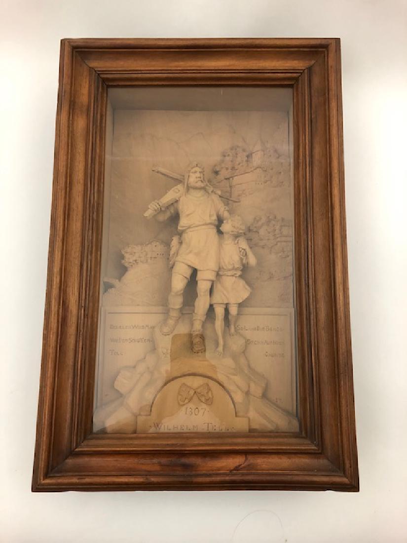 An antique black forest carving of William Tell,: An antique black forest carving of William Tell, (Swiss), with his son and his famous crossbow over his back. Mounted in a frame dispaly case. Marked "Interlake" on the back of case. Overall with fram