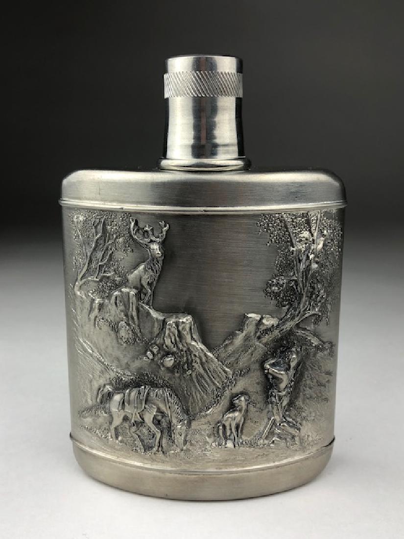 Vintage German pewter flask: Vintage German pewter flask decorated with a hunting scene. Marked "SKS Zinn Made in W. Germany 95%". Height 5 3/4 inches.