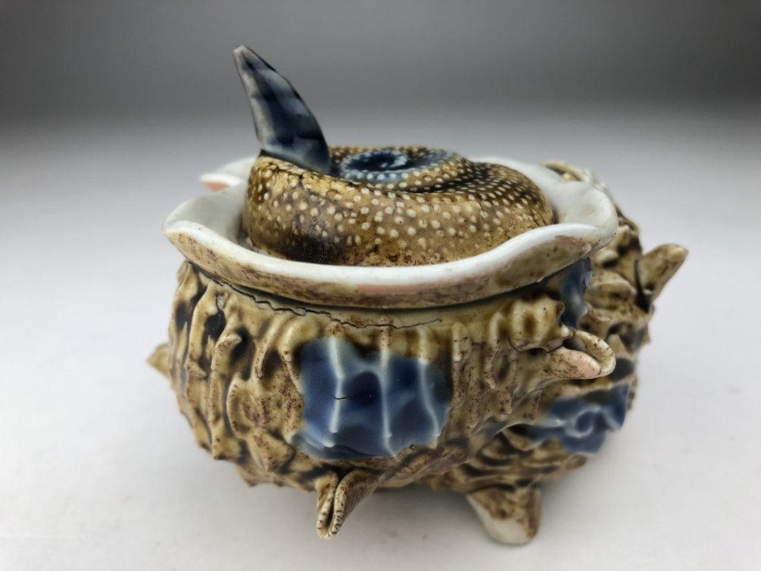 A large Hirado sea shell covered box with applied shell: A large Hirado sea shell covered box with applied shells and objects applied to the body and top of the jar. Three of the shells with movable pieces.Circa 1880.Diameter 3 3/4 inches. Height 3 inches.