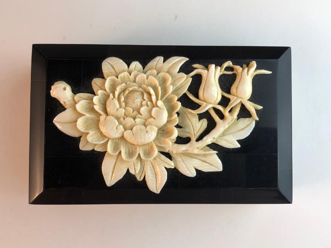 Antique Japanese box with applied bone flower and: Antique Japanese box with applied bone flower and mother of pearl inserts. 5 1/4 inches x 3 1/8 inches x 2 inches high.
