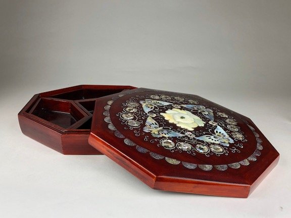 Large wood and Mother of Pearl octagon shape storage: Large wood and Mother of Pearl octagon shape storage box with five internal wood inserts. Decorated with rings of flowers and four butterflies with a central medalion of a large flower with a small fl