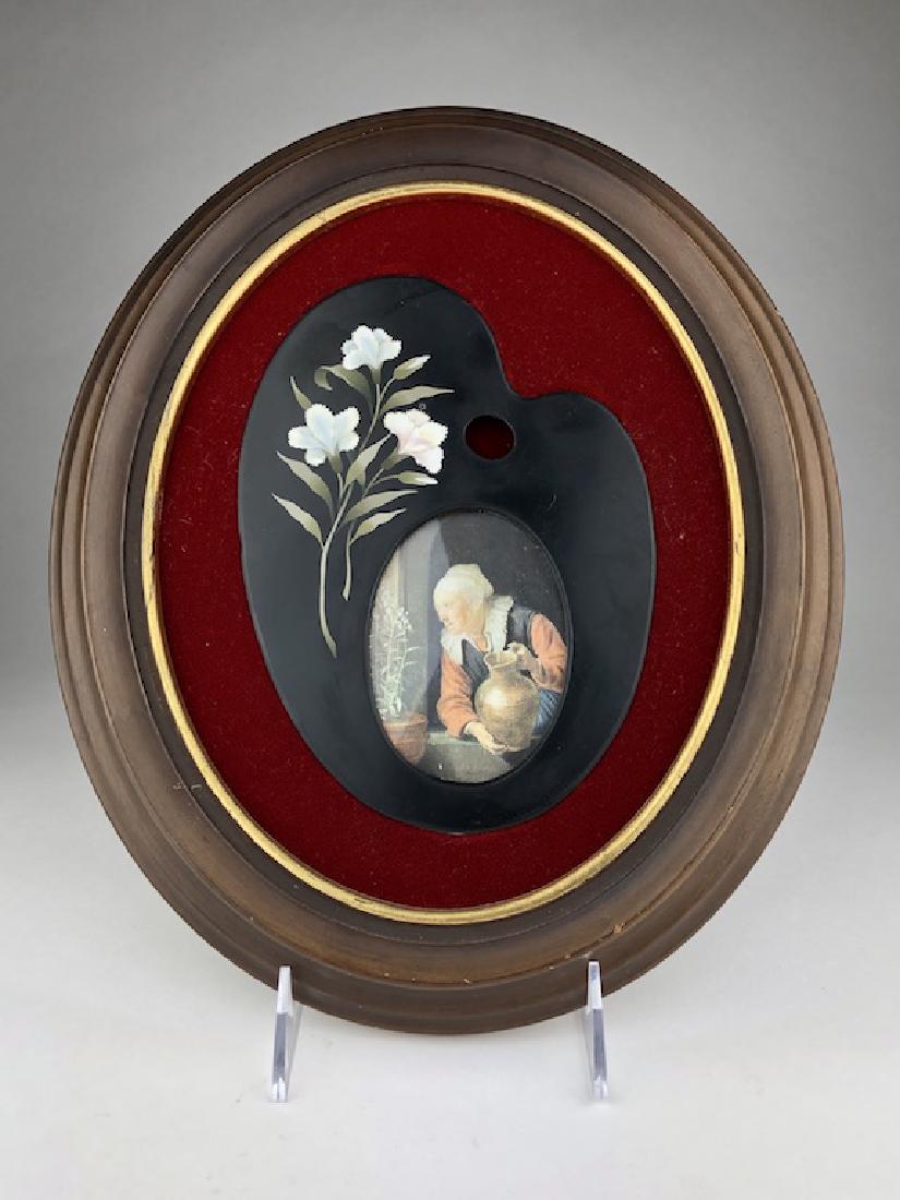 Framed pietra dura plaque as an artist easel: Framed pietra dura plaque as an artist paint pallate. Insert of a photograph of a painting by Gerard Dou, 1613-1675. "Old Woman Watering Flowers". Plaque measures 5 1/2 inches x 7 1/2 inches. Overall 