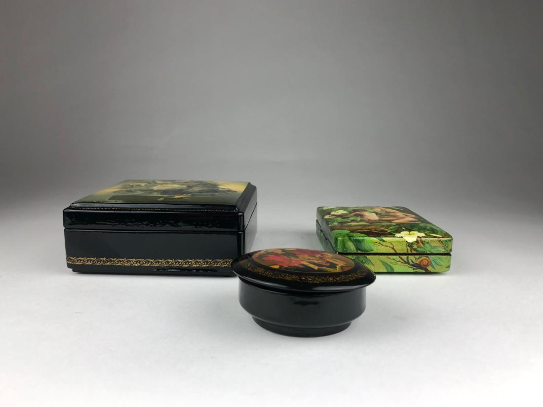 Three Russian paper mache and lacquer boxes.: Three Russian paper mache and lacquer boxes. All artist signed. Largest 4 1/2 inches x 4 1/2 inches x 2 inches tall. Smaller 3 1/4 inches x 4 1/2 inches x 1 1/8 inches high. Round box 3 inche diameter
