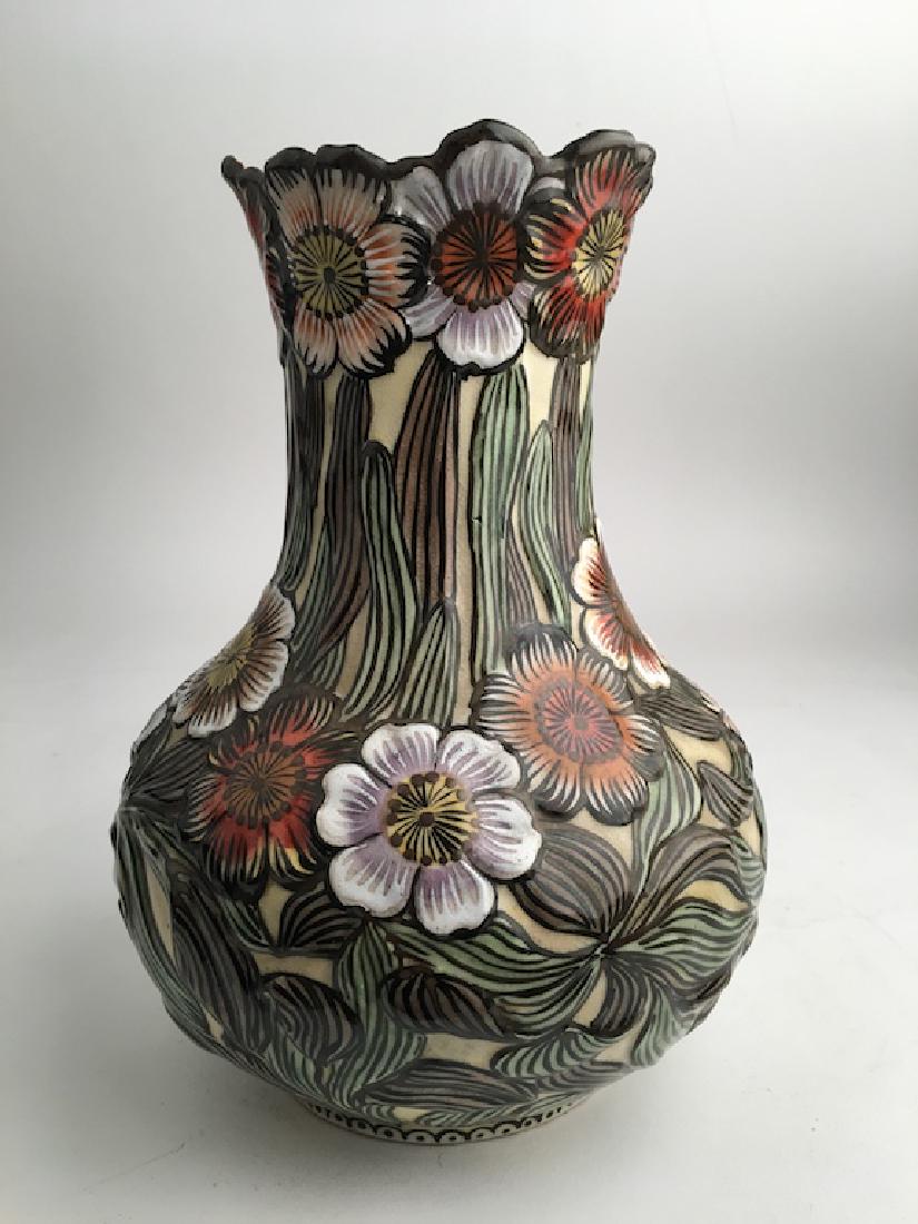 Early 20 th Century Earthenware Japanese vase: Early 20 th Century Earthenware Japanese vase with highly stylized flowers and stems with the flower pedals making scalloped top rim. Artist signed. Height 9 3/4 inches.