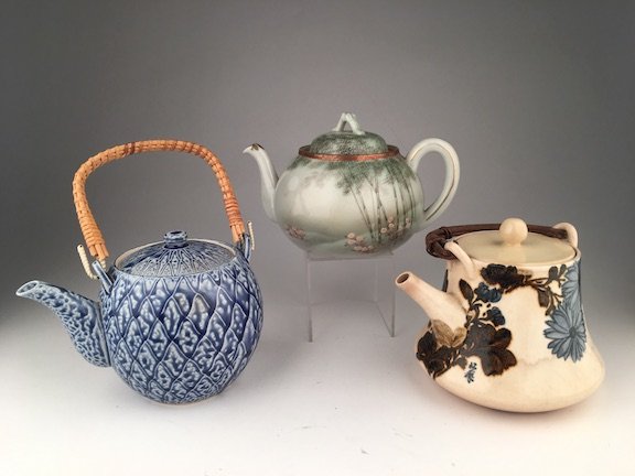 Three Japanese tea pots: Three Japanese tea pots with attached handles. Tallest with handle up 7 inches.