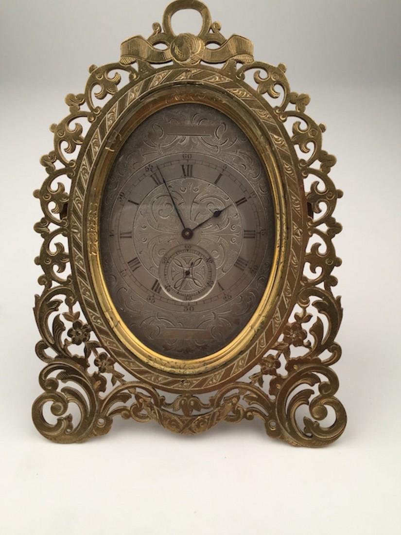 SIMILAR TO THOMAS COLE STRUTT CLOCK: A VERY NICE STRUTT CLOCK IN THE MANNER OF THOMAS COLE. A VERY NICELY ENGRAVED SILVER DIAL WITH A SUB SECOND MOVEMENT PAINTED ROMAN NUMERALS AS WELL AS FIVE MINUTE INTERVALS. THE OVAL CASE IS A PIERCED