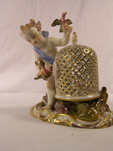MEISSEN FIGURE OF A PUTTI WITH BIRD CAGE. CROSSE - 2