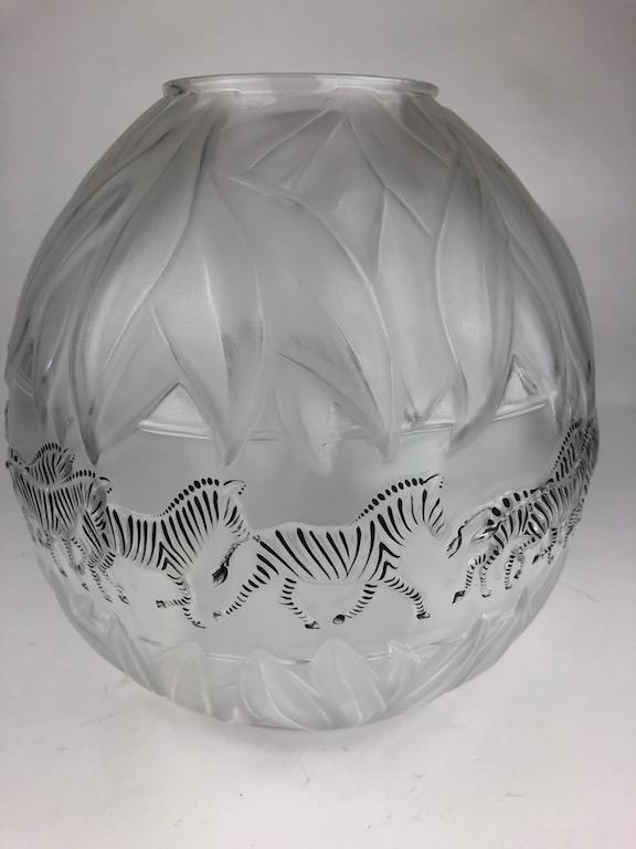 R. Lalique "Tanzania" vase decorated with black: R. Lalique "Tanzania" vase decorated with black enameled zebras all around with top and bottom bands of foliage in clear and frosty glass. Etched "M. Lalique France 10-23-93" on the bottom. Height 8 i