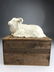 A wonderful porcelain model of a reclining goat in a hi