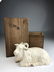 A wonderful porcelain model of a reclining goat in a hi - 3