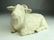 A wonderful porcelain model of a reclining goat in a hi - 4
