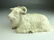 A wonderful porcelain model of a reclining goat in a hi - 5
