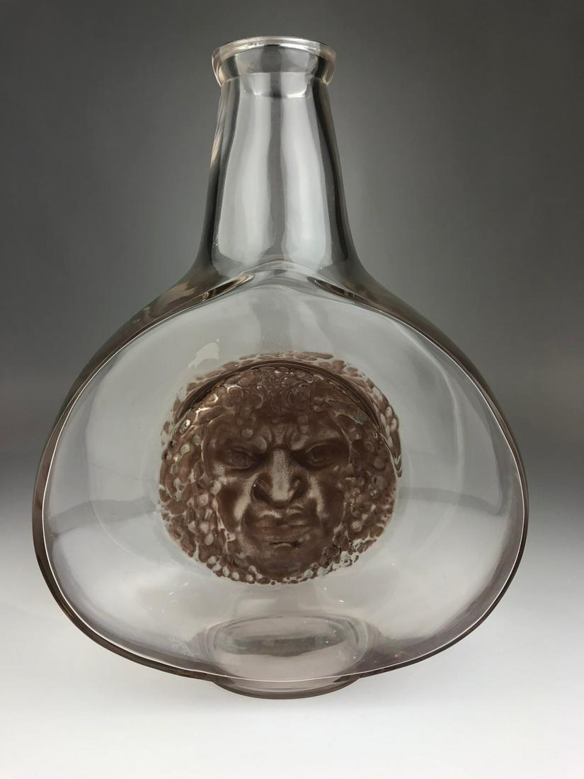 Lalique "Solein" vase in clear glass with a center with: Lalique "Solein" vase in clear glass with a ceter face with sepia patina. Signed " R. Lalique" in srcipt to the bottom side. Height 10 inches. Reference; R. Lalique by Felix Marcilhac, page 422.