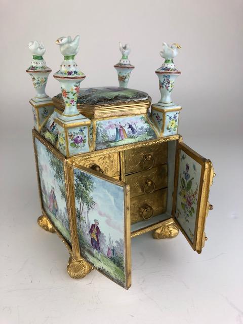 Sevres painted porcelain casket box with top: Sevres painted porcelain casket box with top compartment as well as five gold gilt slide out drawers. Circa 1880. Overall height 6 3/4 inches. Width 4 inches. Depth 3 1/2 inches.