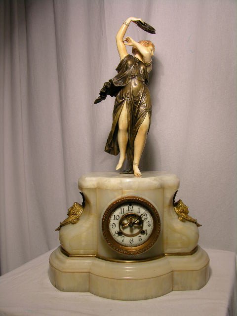 BRONZE AND CARVED MANTEL CLOCK.