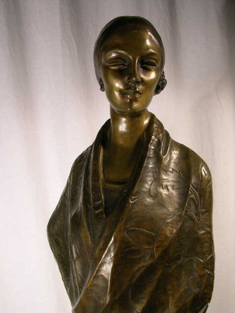 BRONZE FIGURE OF A LADY WEARING A FLOWING DRESS.