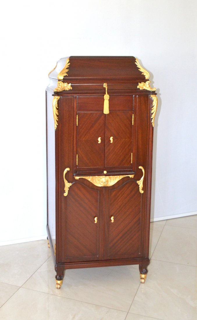 One of Victor's rarest and prettiest phonographs, ofte: One of Victor's rarest and prettiest phonographs, often considered to be the Holy Grail for Victrola collectors. The Laguna Mahogany cabinet and ornate gold-leaf trim make this model a standout. Costi