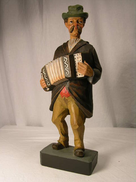 CARVED WOOD WHISTLER FIGURE.