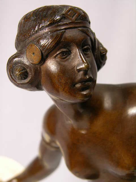 BRONZE CARVED FIGURE OF A FEMALE WARRIOR.