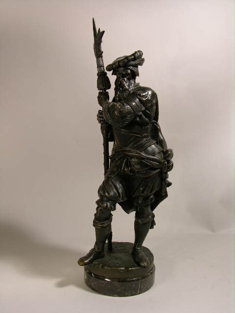 A. CARRIER BRONZE FIGURE OF A MAN WITH WEAPON.