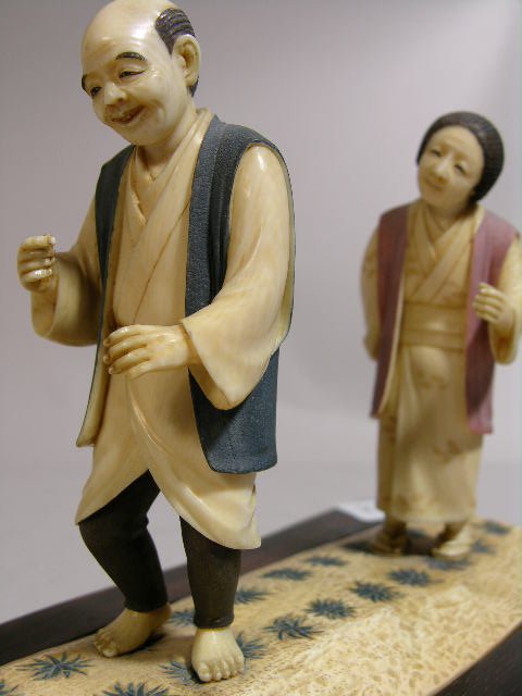 IVORY CARVING OF A MAN AND WOMEN IN A RICE PATTY. - 2