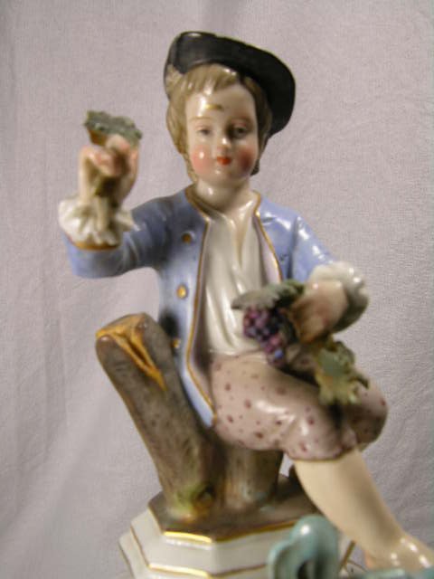 PORCELAIN MANTEL CLOCK WITH FOUR FIGURINES. CHIP - 3