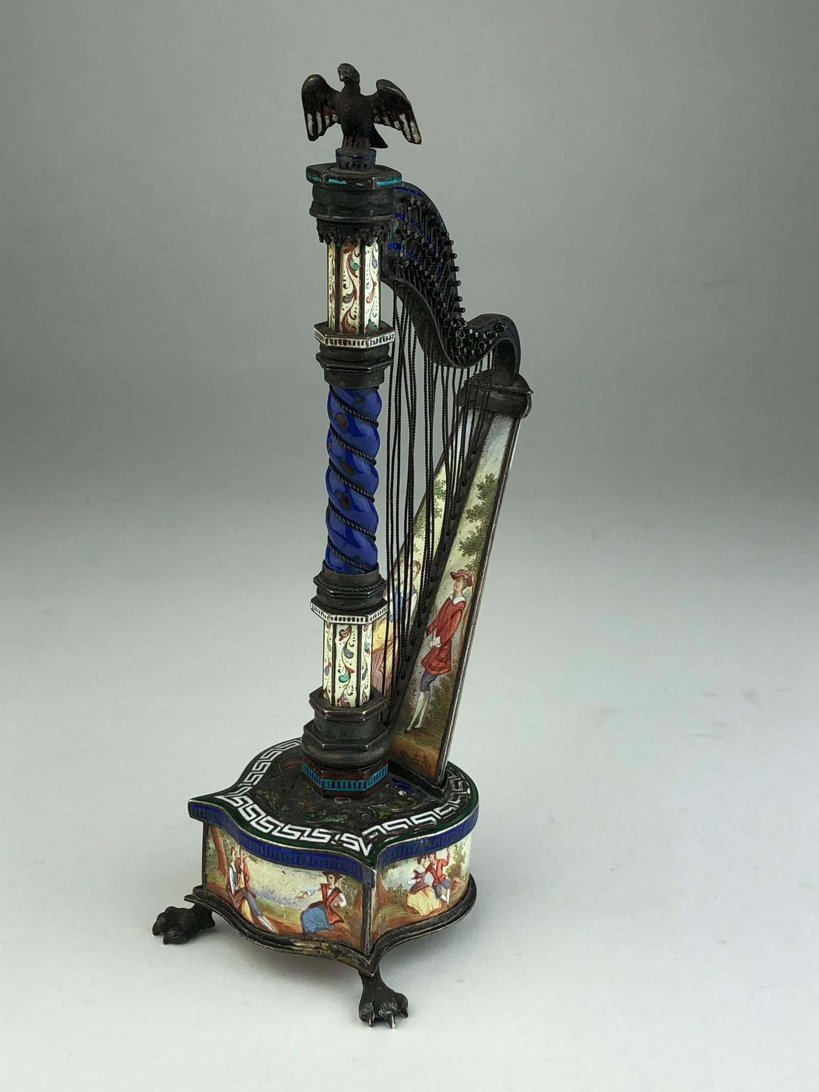 Circa 1880 Viennese enamel musical harp.: Circa 1880 Viennese enamel musical harp. When the harp is flipped back a small box is revealed. Overall height 6 34 inhces. (A very small chip to under side, see photo).