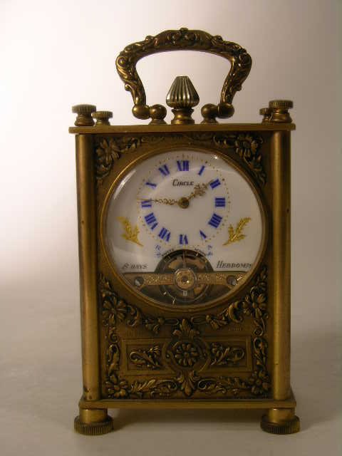 RARE BRONZE CARRIAGE CLOCK.: RARE BRONZE CARRIAGE CLOCK. FACE MARKED "8 DAYS HEBDOM" AND STAMPED ""CIRCLE WATCH CORP.". DECORATED ON FOUR SIDES WITH ROMANTIC SCENES. OVERALL HEIGHT 4 1/4".