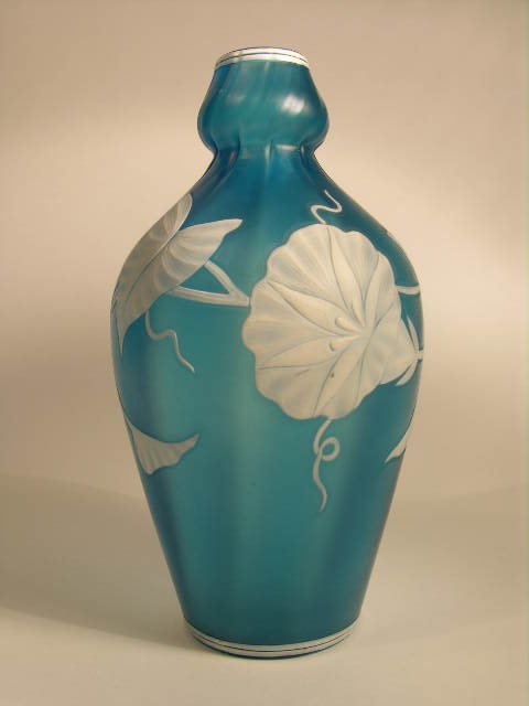 THOMAS WEBB CAMEO VASE.: THOMAS WEBB CAMEO VASE.A VERY UNIQUE FORM THOMAS WEBBVASE, WHITE CAMEO FLOWERS CUT TO A MEDIUM BLUE GROUND.NUMBERED "674 4 1/2" ON BASE.HEIGHT 8".