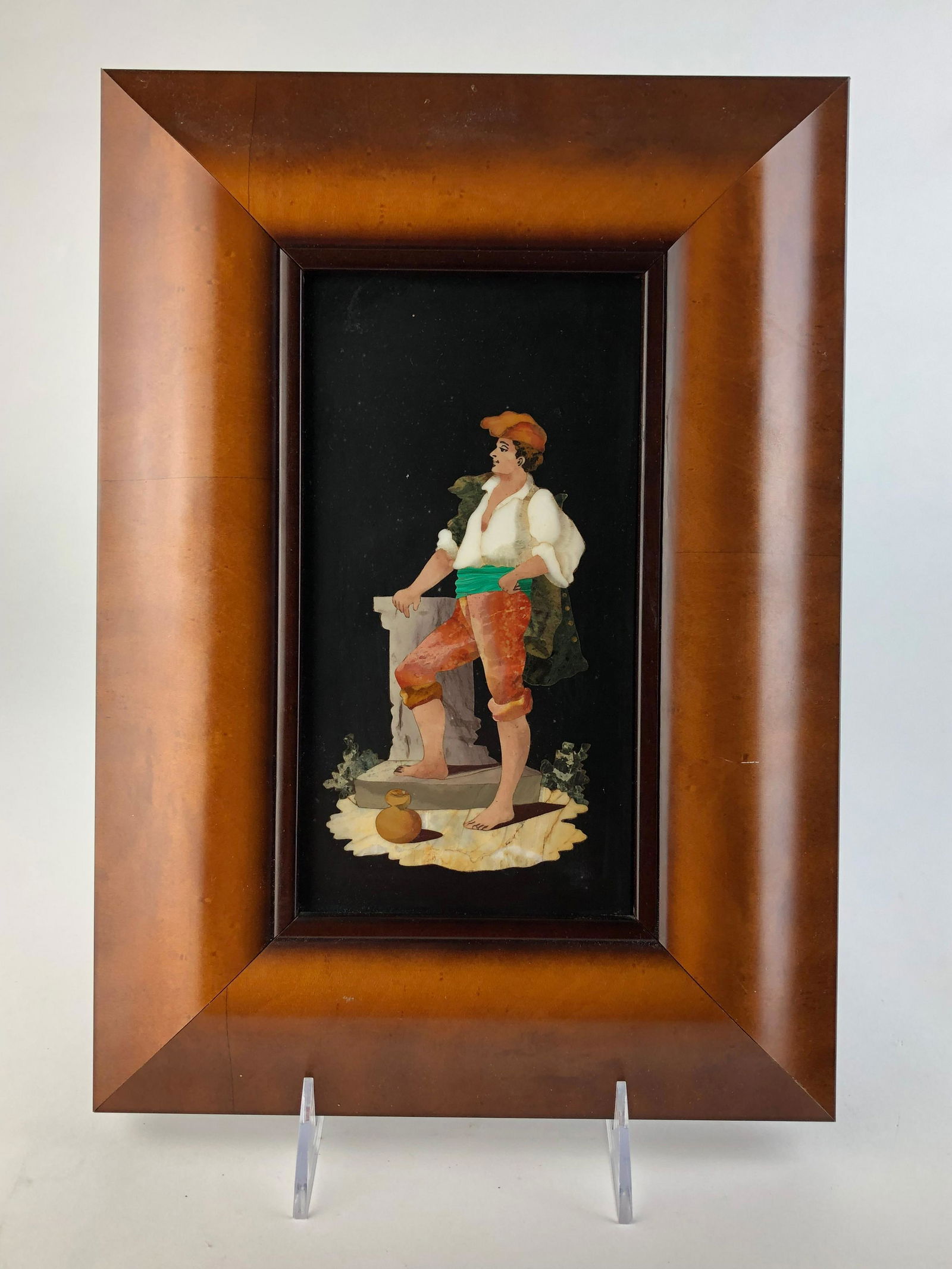 Pietra dura plaque of a man wearing a hat standing with: Pietra dura plaque of a man wearing a hat standing with his right hand on a stand.Plaque measures 4 1/4 inches x 9 inches.Overall with frame 9 inches x 12 1/2 inches.