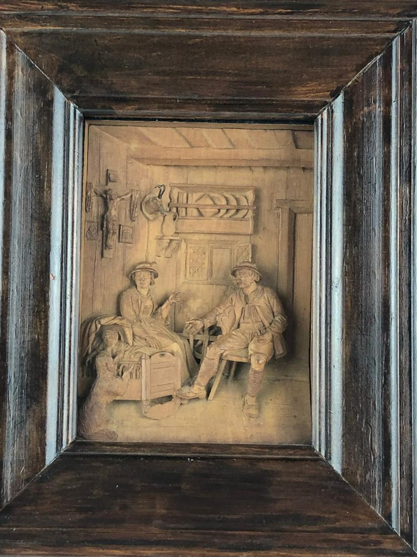 Antique German black forest carving of a group of a: Antique German black forest carving of a group of a young child and parents with a dog playing with the child. Framed in a case. Overall with frame 9 inches x 101/2 inches x 2 3/8 inches.
