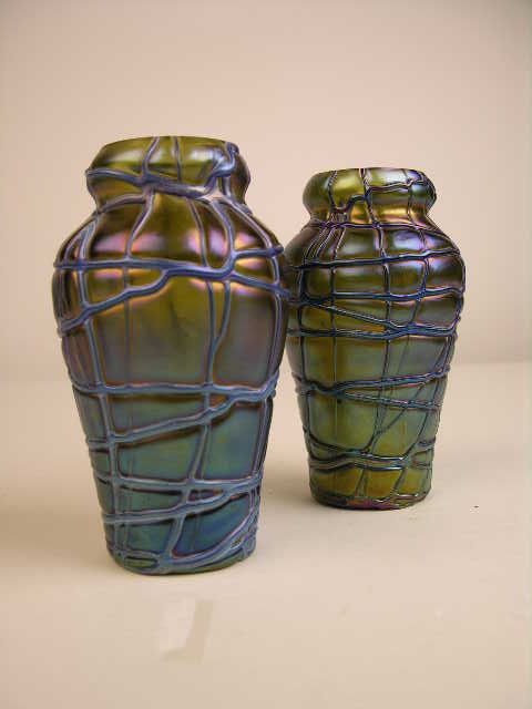 A PAIR OF LOETZ VASES.: A PAIR OF LOETZ VASES. EACH OF THESE SMALL VASES ARE RIBBED IN A ABSTRACT GEOMETRIC PATTERN THE BASE OF EACH VASE SIGNED "LOETZ AUSTRIA". HEIGHT 5".