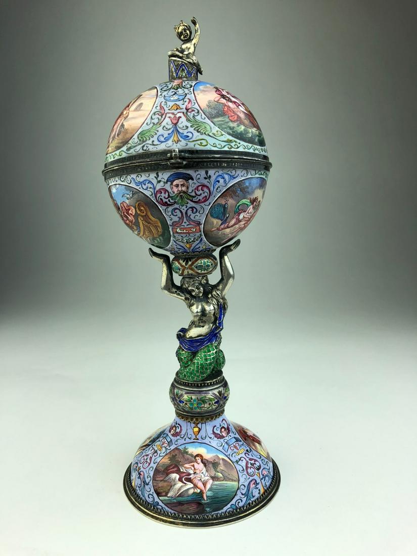 Antique Viennese enameled silver watch box in the shape: Antique Viennese enameled silver watch box in the shape of a globe supported by a semi nude mermaid. Decorated with Allegoric sceens within nine round and oval cartouches. Overall height 8 3/4 inches.
