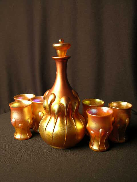 SET OF SIX TIFFANY "MOREVAIGNIAN" SHOT GLASSES.: SET OF SIX TIFFANY "MOREVAIGNIAN" SHOT GLASSES. WITH APPLIED TEARS AND MATCHING DECANTER. (DECANTER HAS BEEN PROFESSIONALLY REPAIRED). HEIGHT OF DECANTER WITH STOPPER IN PLACE 9". HEIGHT OF GLASSES 3 