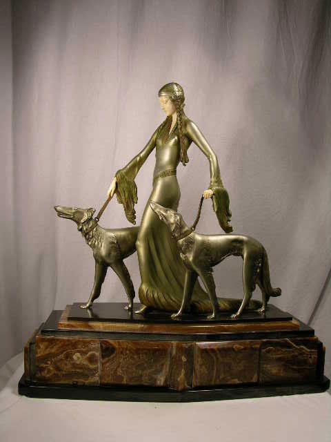 OTTO POERTZEL BRONZE LADY AND IVORY FIGURE:O. POER: OTTO POERTZEL BRONZE LADY AND IVORY FIGURE OF A WOMAN WALKING HER TWO HOUNDS MOUNTED ON A MARBLED BASE. TITLED "MEDIEVAL LADY WITH TWO HOUNDS".SIGNED "PROF. POERTZEL" (O. POERTZEL:1876-1963) IN THE BR