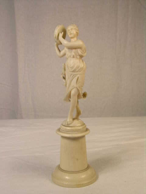 EUROPEAN IVORY CARVING OF BAREFOOTED WOMAN PLAYING