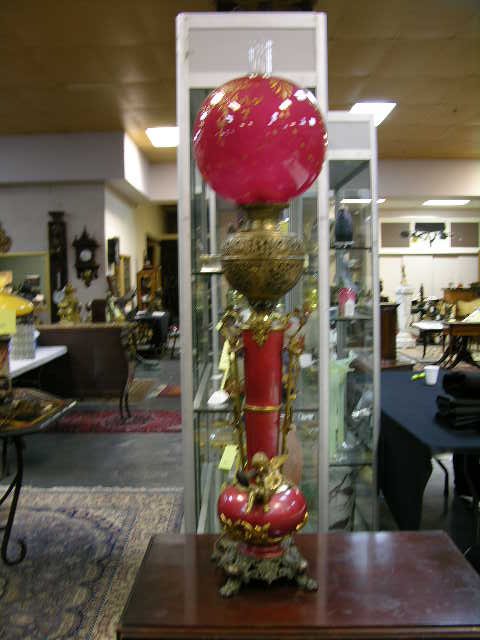 TALL PARLOR LIGHT WITH A CRANBERRY SHADE.