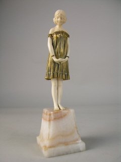 DEMETRE H. CHIPARUS (1886-1947) "INNOCENCE".: DEMETRE H. CHIPARUS (1886-1947) GILT BRONZE AND IVORY FIGURE TITLED "INNOCENCE". THE BAREFOOTED YOUNG LADY WITH HER HANDS CLASPED IN FRONT OF HER WITH HER HEAD LOKING DOWNWARDS TO THE GROUND. THIS FIG