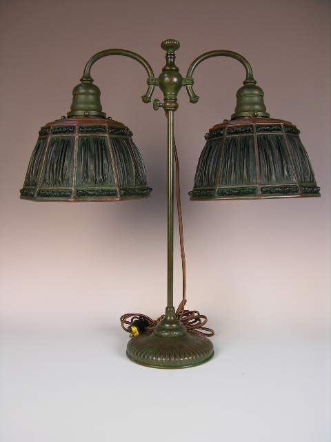 TIFFANY DOUBLE STUDENT LAMP.: TIFFANY DOUBLE STUDENT LAMP WITH GREEN LINENFOLD SHADES. EACH SHADE STAMPED "TIFFANY STUDIOS NEW YORK PATTEN APPLIED FOR". THESE LAMPS ARE AS GOOD AS THEY GET. OVERALL HEIGTH 19 1/2". SHADES MEASURE 7