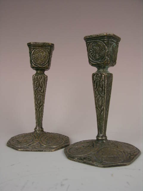 TIFFANY STUDIOS "ZODIAC" CANDLESTICKS.: A PAIR OF TIFFANY STUDIOS "ZODIAC" GILT SILVER CANDLESTICKS. PROPERLY MARKED "TIFFANY STUDIOS NEW YORK 1807". HEIGHT 5 1/2". CIRCA 1920.