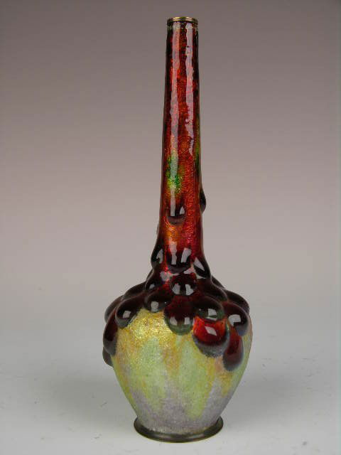 CAMILLE FAURE (CAMILLE FAURE:FRENCH 1874-1956) ENA: CAMILLE FAURE (CAMILLE FAURE:FRENCH 1874-1956).A VERY NICE SHAPED ENAMELED VASE WITH WHAT APPEARS TO BE LARGE ROUND CLUSTERS OF DEEP RED ENAMEL RUNNING DOWN THE SIDE.SIGNED " C. FAURE LIMOGES".HEIGHT