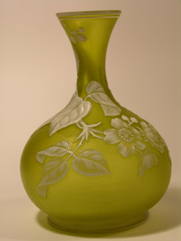 WEBB (ENGLISH) CAMEO VASE.: WEBB (ENGLISH) CAMEO VASE.CITRON COLORED VASE WITH A WHITE OVERLAY CAMEO DECORATION OF SUNFLOWERS, LEAVES AND STEMS WITH TWO BUTTERFLIES.HEIGHT 5 3/4". CIRCA 1890.
