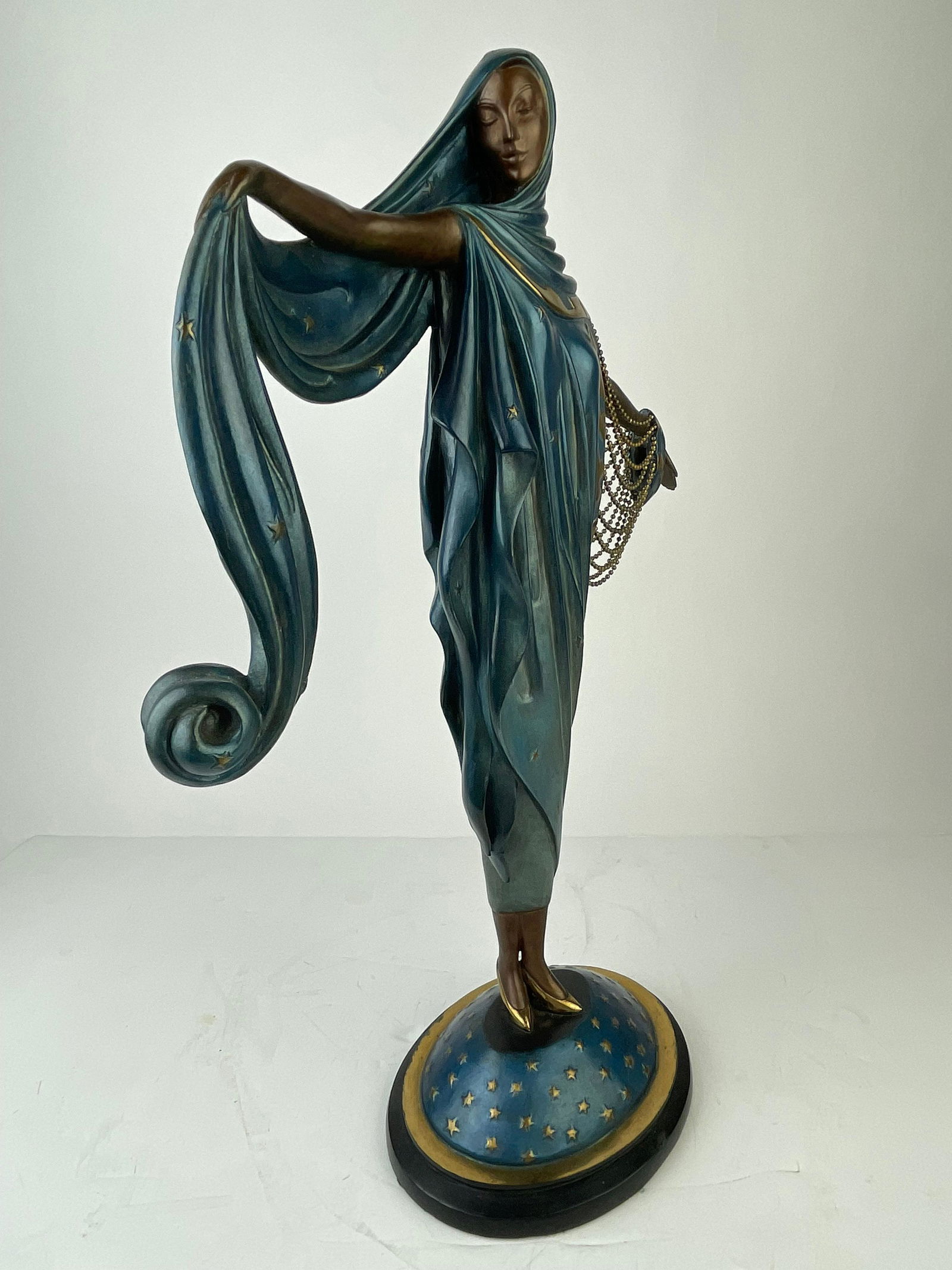 Erte (Romain De Tiftoff) "Moonlight" a patinated bronze: Erte (Romain De Tiftoff) "Moonlight" a patinated bronze figure of a lady standingand wearing a long flowing gown with draping beads.Stamped "48/375 C 1985 Fine Arts Acqisations"Also stamped with the E
