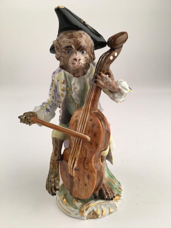 Meissen monkey band member playing a cello.: Meissen monkey band member playing a cello. Properly marked with Meissen crossed swords. Height 4 3/4 inches.