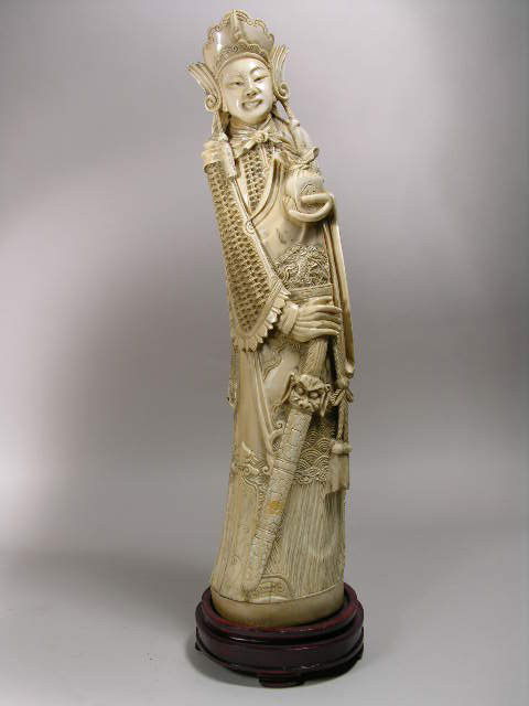 IVORY CARVING OF A WOMAN.: AN IVORY SCULPTURE OF A JAPANESE WOMAN WEARING A LONG ROBE WITH A JAR IN HER LEFT HAND. HEIGHT OF CARVING 14 1/2". OVERALL WITH WOOD BASE 15 1/2". WE WILL NOT SHIP OUTSIDE THE UNITED STATES IN ACCORDA