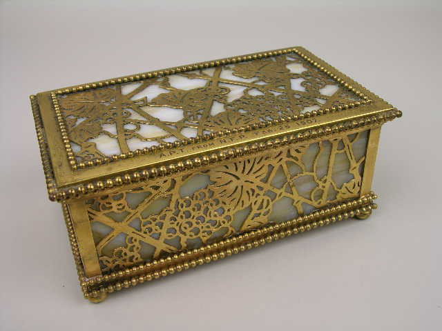 TIFFANY STUDIOS GRAPEVINE JEWERLY BOX.: TIFFANY STUDIOS GRAPEVINE JEWERLY BOX WITH CAMEL COLORED GLASS AND ORIGINAL LINED DIVIDER. BEADED ON ALL FOUR SIDES AND SUPPORTED ON FOUR SMALL BUNN FEET. THE TOP IS STAMPED "A.P.T. FRON N.F.P. FEB. 2