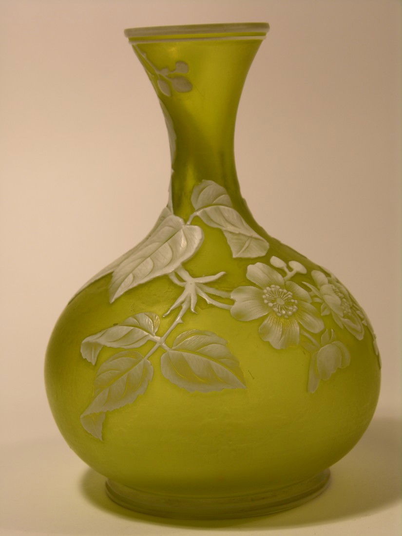 WEBB (ENGLISH) CAMEO VASE.: WEBB (ENGLISH) CAMEO VASE.CITRON COLORED VASE WITH A WHITE OVERLAY CAMEO DECORATION OF SUNFLOWERS, LEAVES AND STEMS WITH TWO BUTTERFLIES.HEIGHT 5 3/4". CIRCA 1890.