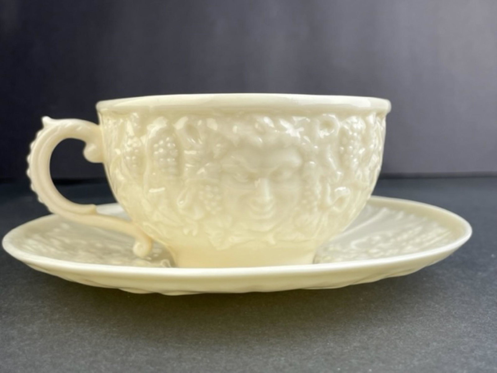 Belleek Ireland bone china Bacchus face mask tea cup and saucer.: Belleek Ireland bone china Bacchus face mask tea cup and saucer. Bothe properly marked. Sauce diameter 3 1/2 inches.