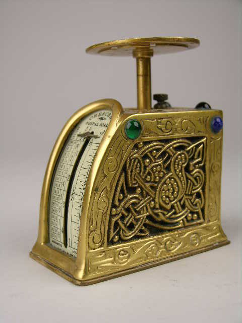 TIFFANY STUDIOS "NINTH CENTURY" BRONZE POSTAL SCAL: TIFFQNY STUDIOS BRONZE POSTAL SCALE IN THE "NINTH CENTURY" PATTERN. ALL EIGHT JEWELS INTACT. PROPERLY MARKED TIFFANY STUDIOS NEW YORK 1627. SOME DAMAGE TO FRONT OF SCALE. 3 1/2" HIGH. CIRCA 1920.