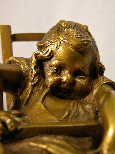 JUAN CLARA (SPANISH 1875-1957) BRONZE FIGURE.: JUAN CLARA (SPANISH 1875-1957) BRONZE FIGURE. JUAN CLARA BRONZE FIGURE OF A LITTLE GIRL (SUZETTE). SITTING IN A HIGH CHAIR. SIGNED "JUAN CLARA" IN THE BRONZE. OVERALL HEIGHT 6 ". CIRCA 1920.